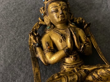 A Sino-Tibetan inlaid gilt bronze figure of Buddha, Ming