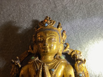 A Sino-Tibetan inlaid gilt bronze figure of Buddha, Ming