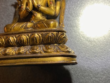 A Sino-Tibetan inlaid gilt bronze figure of Buddha, Ming