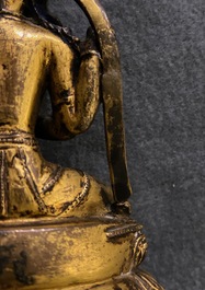 A Sino-Tibetan inlaid gilt bronze figure of Buddha, Ming