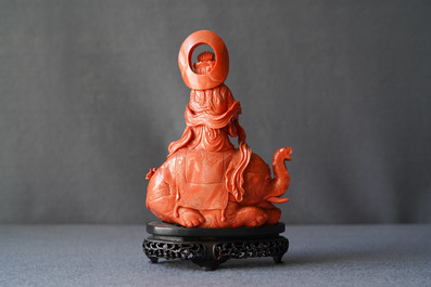 A Chinese carved red coral group of Guanyin on an elephant, 19th C.