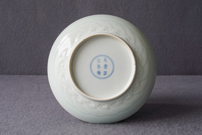 A Chinese celadon saucer dish with underglaze design, Yongzheng mark and poss. of the period