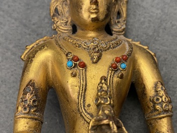 A Chinese coral- and turquoise-inlaid gilt bronze figure of Buddha Amitayus, 18/19th C.