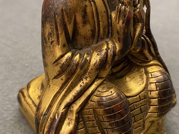 A Sino-Tibetan gilt bronze figure of a Lama, 19th C.