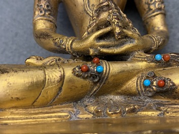 A Chinese coral- and turquoise-inlaid gilt bronze figure of Buddha Amitayus, 18/19th C.