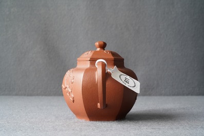 A Chinese Yixing stoneware teapot and cover with applied prunus design, Kangxi