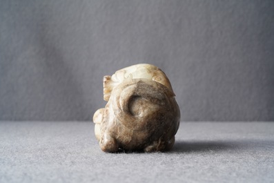 A Chinese pale grey-brown jade model of a Buddhist lion, 19/20th C.