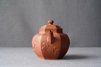 A Chinese Yixing stoneware teapot and cover with applied prunus design, Kangxi