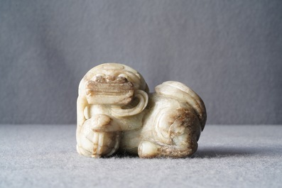 A Chinese pale grey-brown jade model of a Buddhist lion, 19/20th C.