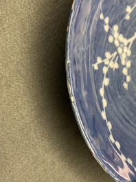 A rare Chinese reverse-decorated 'magpie and prunus' plate, Transitional period