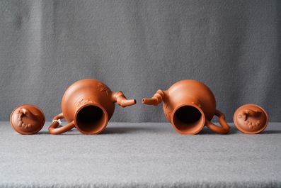 A pair of Chinese Yixing stoneware ewers with applied prunus design, Kangxi