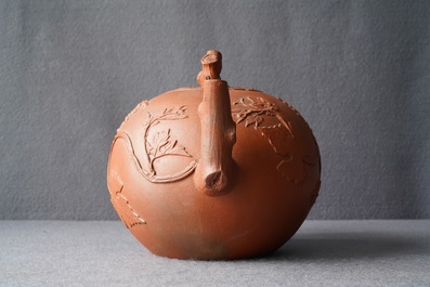 A large Chinese Yixing stoneware teapot with applied grape vines design, Kangxi