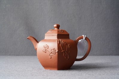 A Chinese Yixing stoneware teapot and cover with applied prunus design, Kangxi