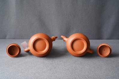 A pair of Chinese Yixing stoneware ewers with applied prunus design, Kangxi