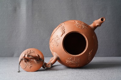 A large Chinese Yixing stoneware teapot with applied grape vines design, Kangxi