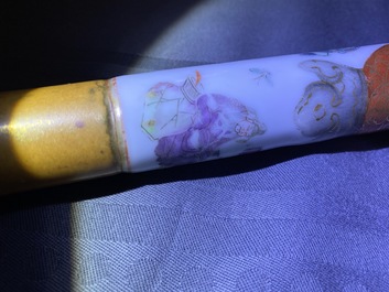 A Chinese famille rose opium pipe with silk pouch, 19th C.