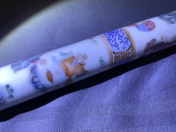 A Chinese famille rose opium pipe with silk pouch, 19th C.