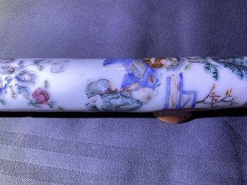 A Chinese famille rose opium pipe with silk pouch, 19th C.