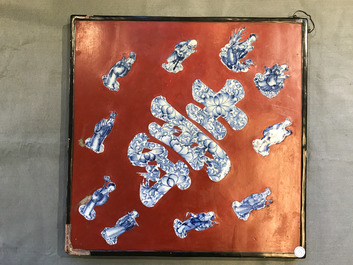 A Chinese red-lacquered plaque with blue and white porcelain inserts, 19/20th C.