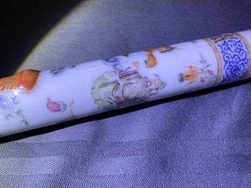 A Chinese famille rose opium pipe with silk pouch, 19th C.