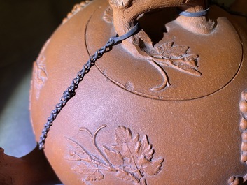 A large Chinese Yixing stoneware teapot with applied grape vines design, Kangxi