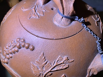 A large Chinese Yixing stoneware teapot with applied grape vines design, Kangxi