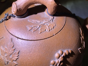 A large Chinese Yixing stoneware teapot with applied grape vines design, Kangxi