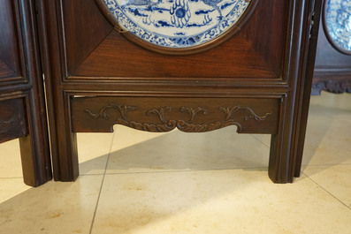 A Chinese wooden room divider with blue and white 'dragon' plaques, 19th C.