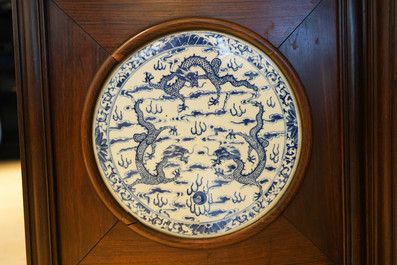 A Chinese wooden room divider with blue and white 'dragon' plaques, 19th C.