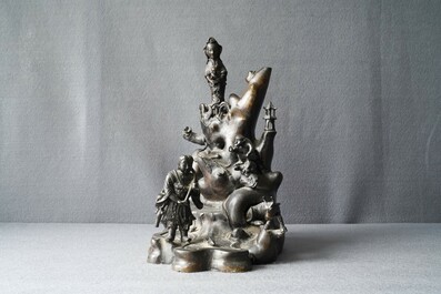 A large Chinese bronze group with Guanyin with child on a rock, Ming
