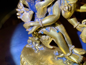 A Sino-Tibetan gilt bronze group of Mahakala and his consort Yab-Yum, 19th C.