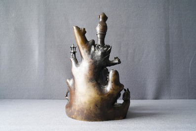 A large Chinese bronze group with Guanyin with child on a rock, Ming
