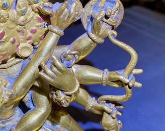 A Sino-Tibetan gilt bronze group of Mahakala and his consort Yab-Yum, 19th C.