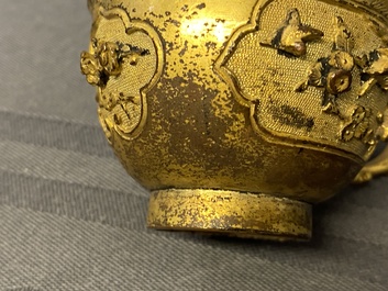 A Chinese relief-decorated gilt bronze cup, Ming