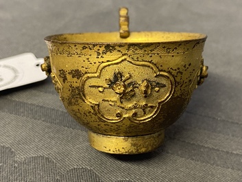 A Chinese relief-decorated gilt bronze cup, Ming