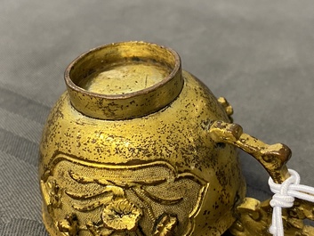 A Chinese relief-decorated gilt bronze cup, Ming