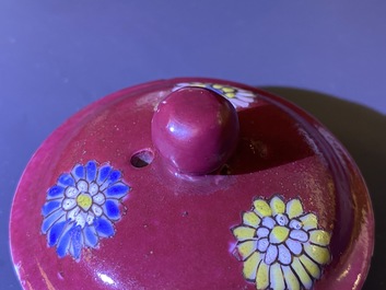 A Chinese famille rose ruby-ground teapot, three cups and two saucers, Yongzheng