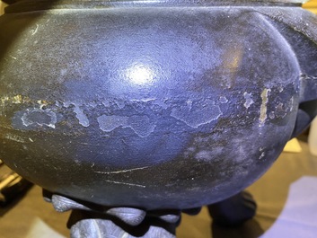 A large Chinese bronze incense burner and cover on carved wooden stand, Ming