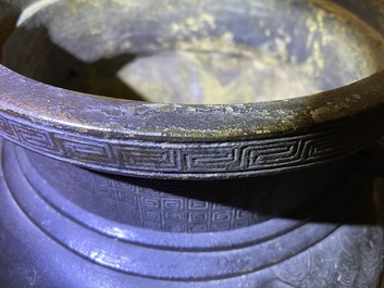 A large Chinese bronze incense burner and cover on carved wooden stand, Ming