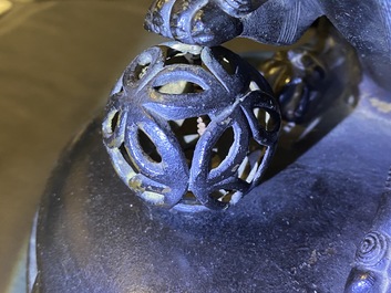 A large Chinese bronze incense burner and cover on carved wooden stand, Ming