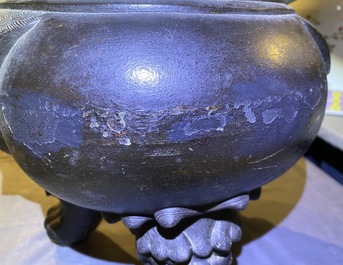 A large Chinese bronze incense burner and cover on carved wooden stand, Ming