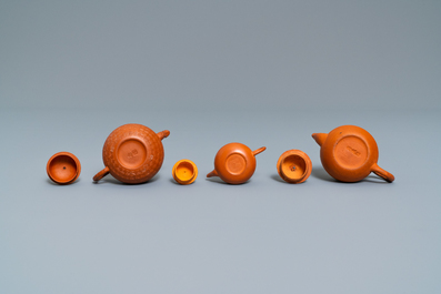 Three Chinese Yixing stoneware teapots and covers, impressed marks, 18/19th C.
