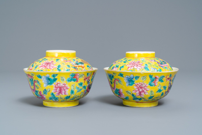 A pair of Chinese yellow-ground famille rose 'dragon and phoenix' bowls and covers, 19th C.