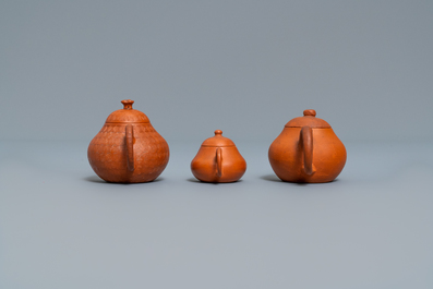 Three Chinese Yixing stoneware teapots and covers, impressed marks, 18/19th C.