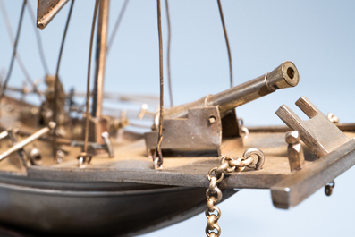 A large Chinese silver model of a junk on carved wooden stand, 19th C.
