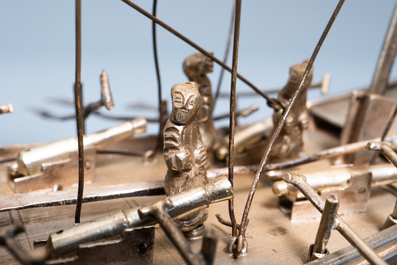 A large Chinese silver model of a junk on carved wooden stand, 19th C.