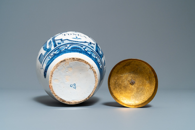 A Dutch Delft blue and white tobacco jar with American Indians and inscribed 'Tonka', 18th C.