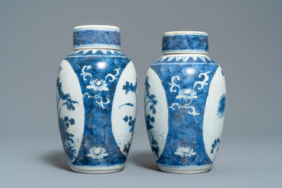 A pair of Chinese blue and white vases and covers with floral design, Hatcher cargo shipwreck, Transitional period