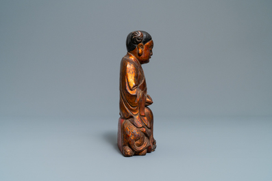A Chinese gilt and laquered wooden group with a boy on an ox, 18/19th C.