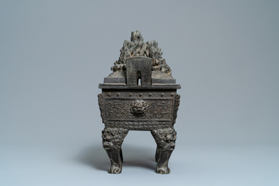 A large Chinese bronze censer and cover with animals near a hilly landscape, Ming